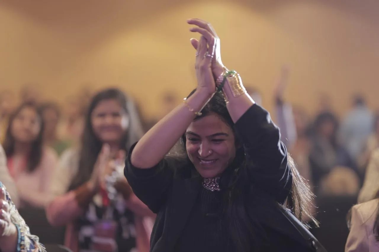 Dr. Jyoti clapping with joy among the audience