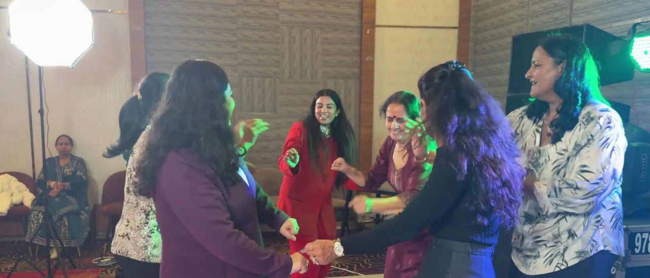 Women dancing together with Dr. Jyoti at the retreat