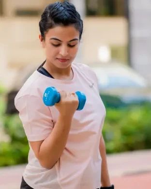 Dr. Jyoti doing a bicep curl with a small weight