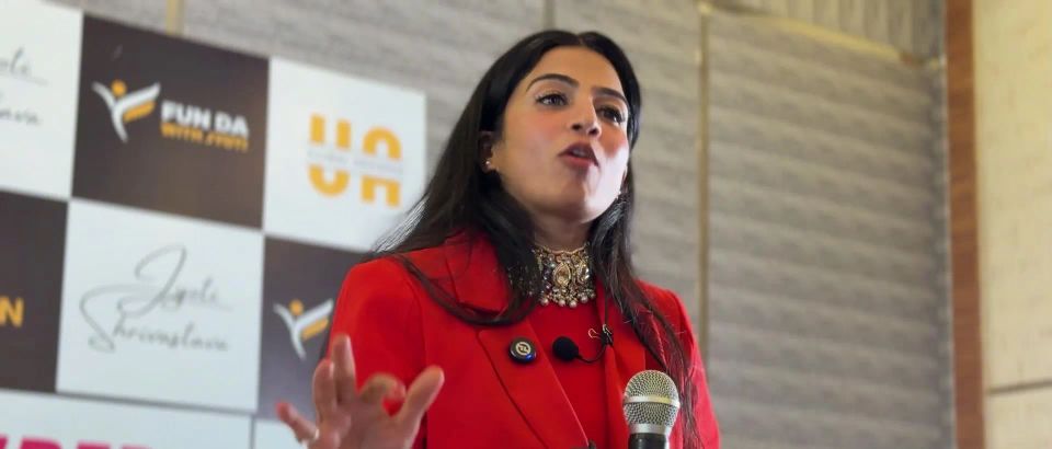 Dr. Jyoti speaking into a microphone at the Superwoman Retreat
