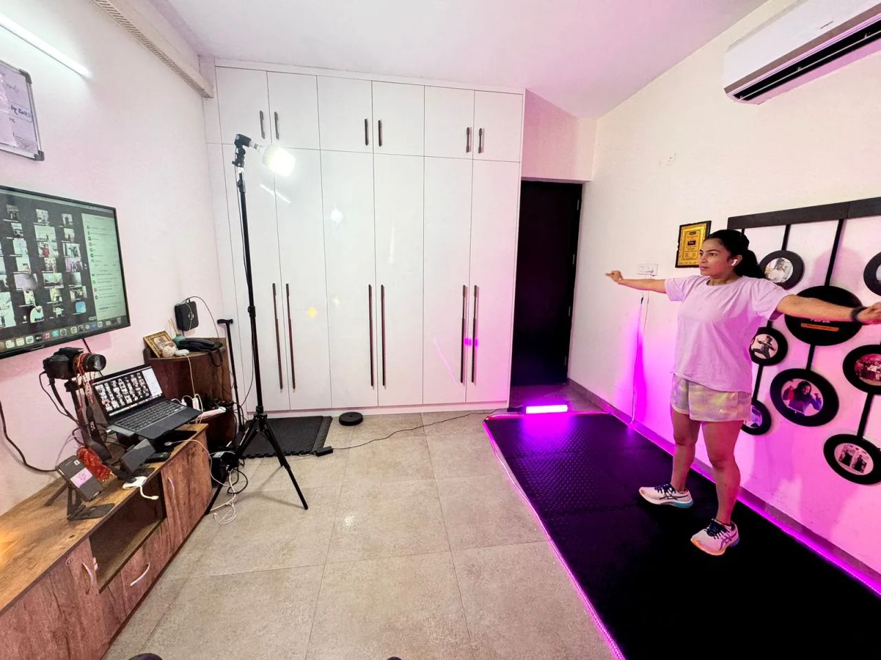 Dr. Jyoti teaching a live FunDa class from her home studio, with members visible on a Zoom screen